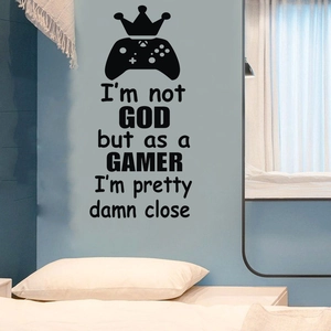 Detailed view of black vinyl game controller wall sticker with crown on blue wall