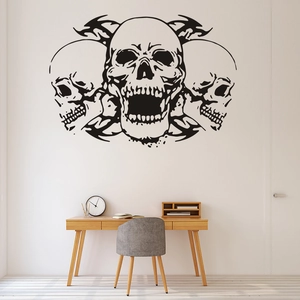 Three gothic skull vinyl wall decals set against a white wall in a modern living room