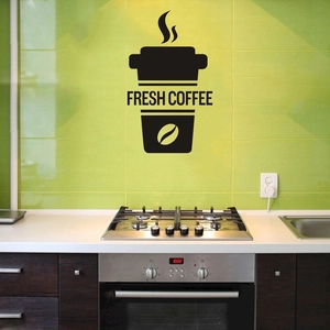 Macro shot of Fresh Coffee wall decal with black cup design on green kitchen tiles