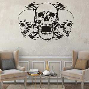 Gothic black skull vinyl wall decal displayed above armchairs in a modern living room