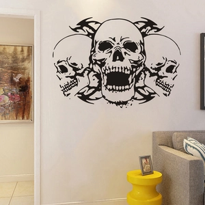 Detail view of black vinyl skull wall decal with flame patterns in a modern living room