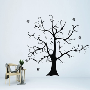 Detail of a large black tree vinyl wall decal with butterflies in a modern living room decor