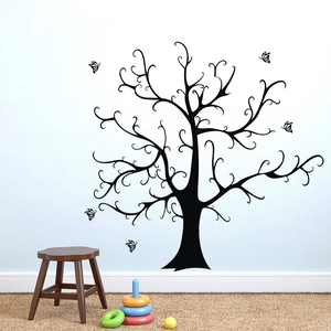 Detailed view of black tree silhouette wall decal with butterflies in a nursery room