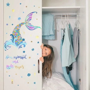 Mermaid wall decals with shells and inspirational text applied on a white cabinet door