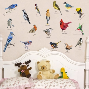 Realistic colorful bird wall decals set for bedroom decor above a white wooden bed headboard