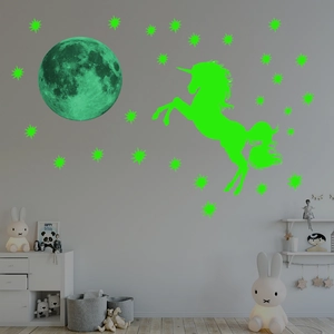 Luminous unicorn and moon wall stickers glowing in a dark kids room for home decoration