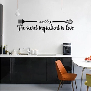 Detail of kitchen wall decal with whisk and brush art and The secret ingredient is love text