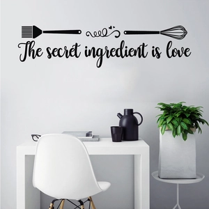 Close-up of kitchen wall decal with The secret ingredient is love text and utensils