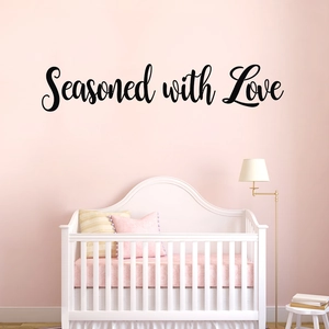 Detail of Seasoned with Love wall sticker with black cursive font on pink wall