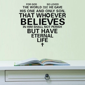Macro detail of BELIEVES bible verse wall decal in heart shape on green wall surface