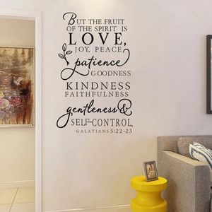 Detail of Bible verse wall decal Fruit of the Spirit is Love on a living room wall