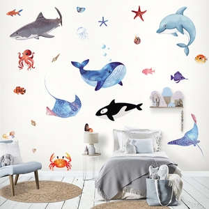 Watercolor ocean life wall stickers featuring whales and sharks in a kids bedroom