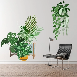 Minimalist green leaf wall decals showing tropical monstera plants in a modern living room