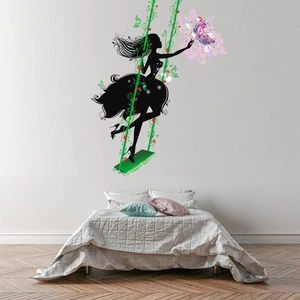 Detail of fairy wall sticker featuring a black silhouette on a swing with flowers and butterfly
