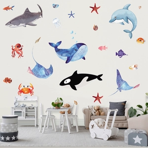 Watercolor marine life wall stickers featuring whales and sharks in a kids nursery setting
