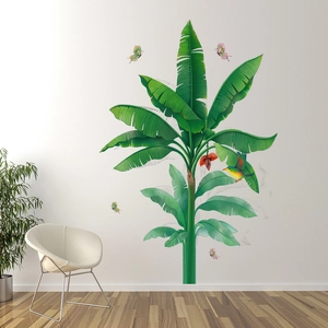 Detail view of tropical banana tree wall sticker with hummingbird and butterflies on white wall