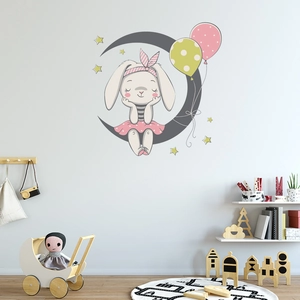 Cartoon rabbit on moon wall decal set displayed in a cozy nursery room setting