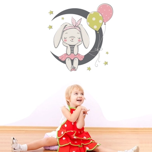 Cartoon rabbit on moon wall sticker with stars and balloons in a kid's bedroom decor