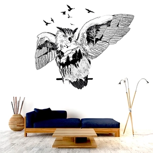 Artistic owl wall decal with forest silhouette detail on a minimalist living room wall