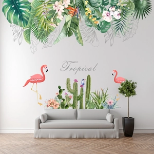 Detail view of Tropical wall decals with flamingos and green plant leaves on white wall