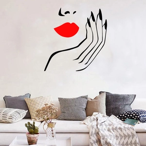 Detail of red lips wall sticker with female face line art above a living room sofa