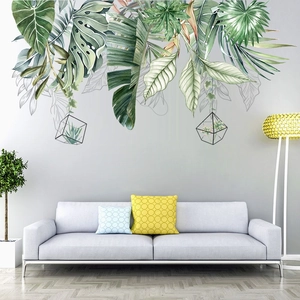 Detail of Nordic tropical leaf wall stickers featuring monstera leaves on a gray living room wall