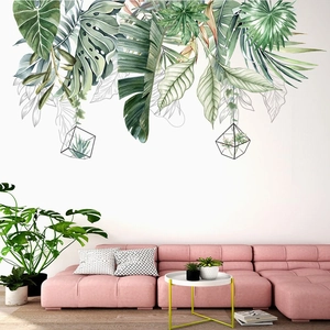 Detail view of tropical monstera leaf wall stickers in watercolor style on a white wall