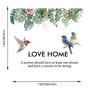 Macro detail of tropical leaf wall sticker with birds and LOVE HOME slogan layout