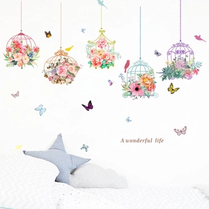 Floral birdcage and butterfly wall stickers with 'A wonderful life' text on a bedroom wall