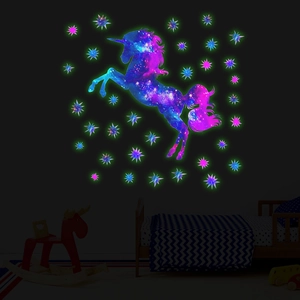Luminous unicorn and colorful stars glowing in a dark children's bedroom setting