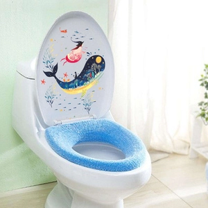 Detailed view of hand-painted whale and girl wall sticker on a white bathroom toilet lid