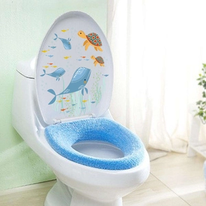 Detail view of blue plush toilet seat cover with cartoon ocean whale stickers