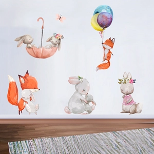 Detail of watercolor fox and bunny wall decals in a cozy children room setting
