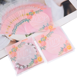 Sachet floral rose auto-adhésif pour biscuits et bijoux avec texte Luck en blanc