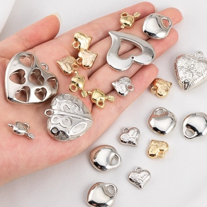 Golden and silver heart charms with floral and love engravings for DIY jewelry making