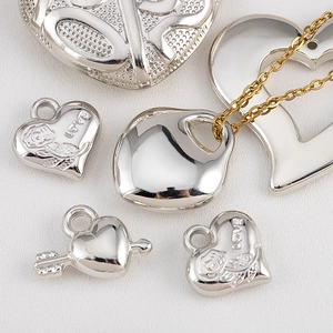 Polished silver and gold heart pendants with LOVE engraving and floral details
