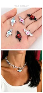 Macro detail of gothic bat eye pendants in silver and black metal frames for DIY necklaces