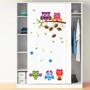 Cute cartoon owl and rugby themed wall decals on a white sliding door wardrobe