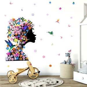 Creative wall decal featuring a floral female silhouette with colorful hummingbirds and butterflies