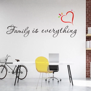 Modern wall sticker featuring Family is everything quote with red heart icon in a room