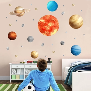 Detailed view of solar system planets wall stickers on a soft pink nursery room wall