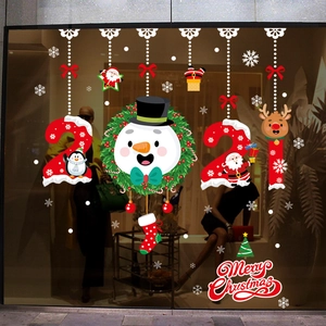 Stickers de Noël pour vitrine avec Père Noël et renne sur une surface en verre lisse