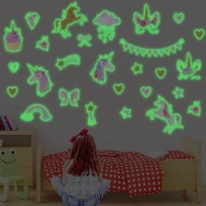 Luminous glow-in-the-dark unicorn wall stickers with stars and rainbow in dark room