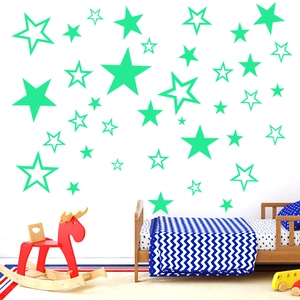 Luminous mint green star wall stickers in various sizes for cozy nursery wall decor