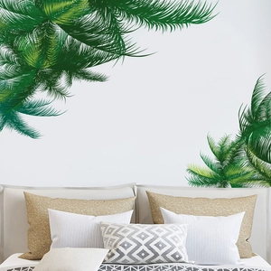 Detailed view of green tropical palm leaf wall decals in a modern bedroom setting
