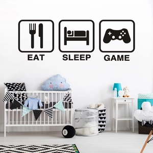 Close-up of Eat Sleep Game black wall decals in a modern minimalist nursery room