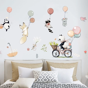 Detailed view of cartoon panda and fox wall stickers in a cozy nursery room setting