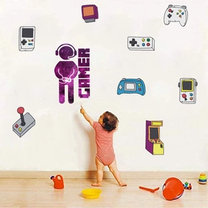 Detailed view of gamer wall decals featuring retro controllers and child for scale