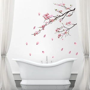 Detail of pink cherry blossom wall stickers with petals on a minimalist bathroom wall