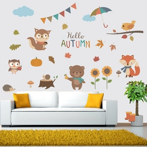 Detail of autumn animal wall stickers featuring a fox, bear, and squirrel on a white wall